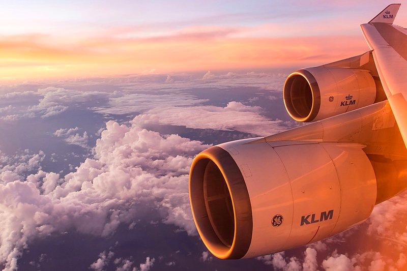 Aircraft engines above the clouds at sunset