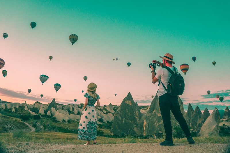 Couple watching hot air balloons rise over Cappadocia