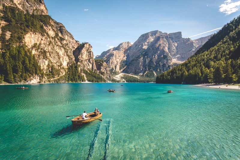 Wooden boat on a turquoise lake in the Italian Dolomites