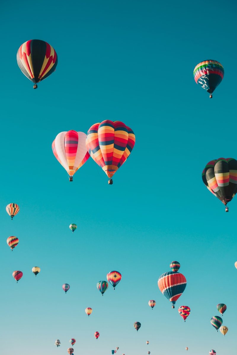 Colorful hot air balloons rising at dawn