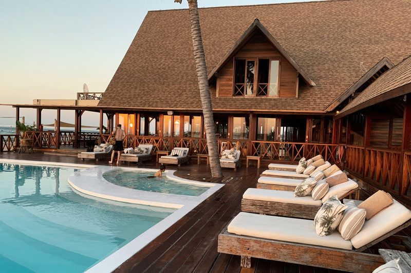 Luxury beachfront resort with infinity pool at sunset