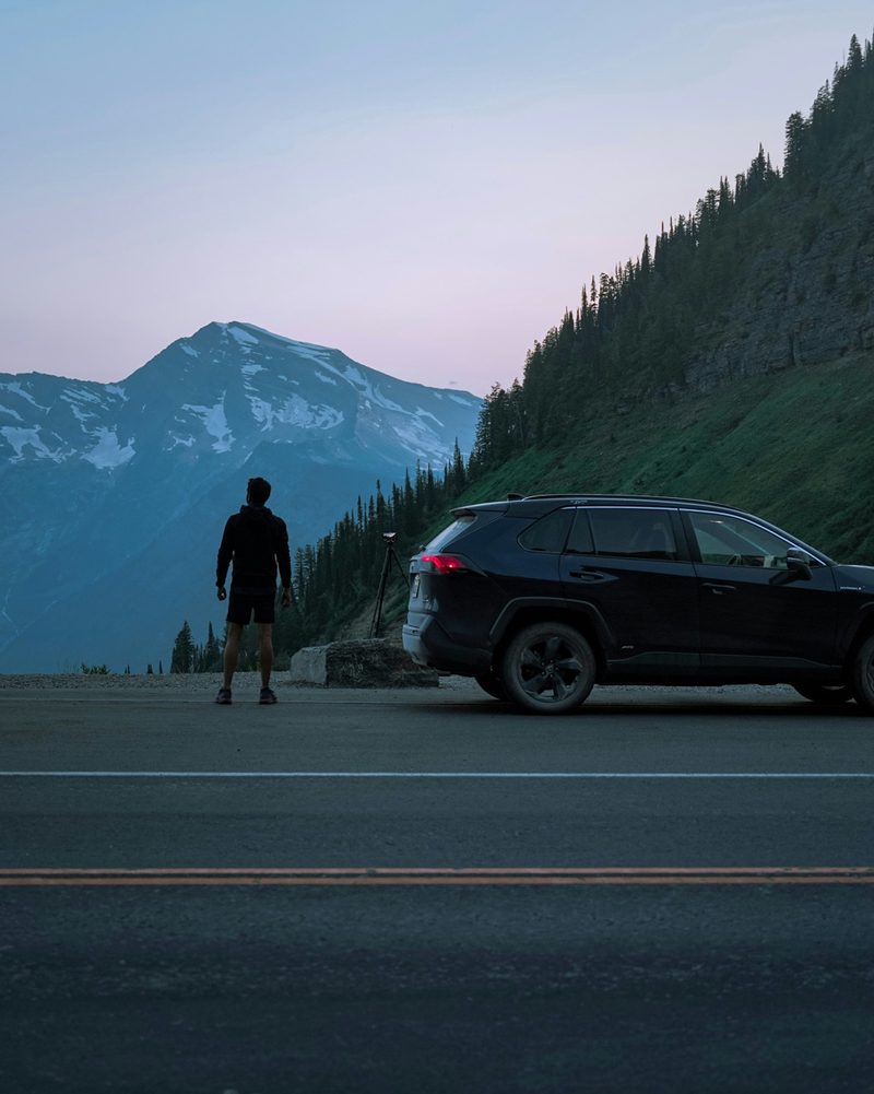 SUV at a mountain viewpoint at twilight